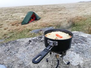 Backpacking tent with camping stove in front. Wild camping on Dartmoor.